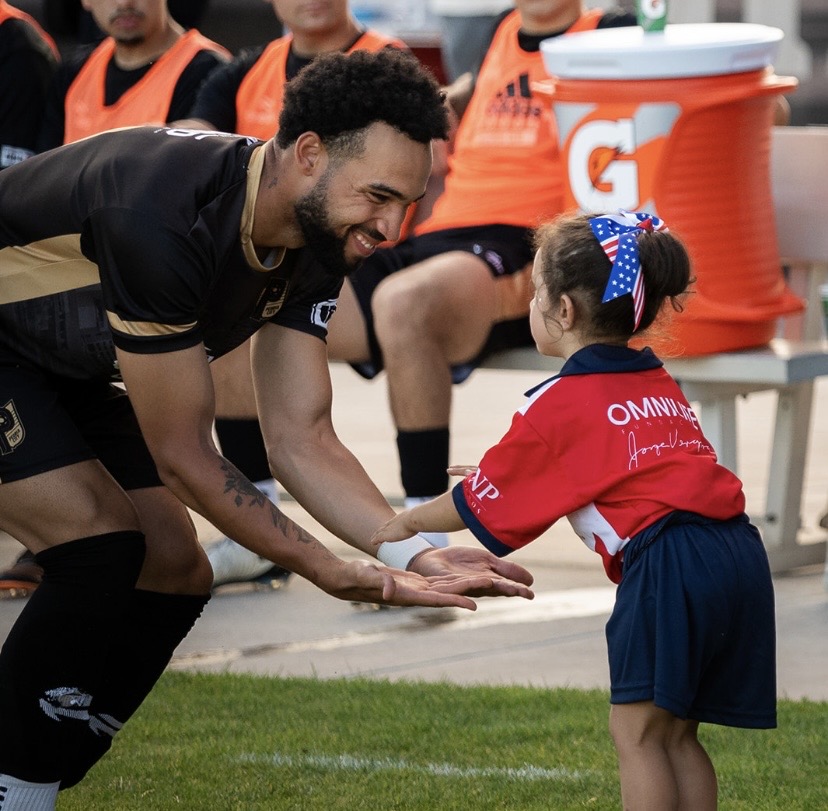 Coach Justin Wilson with young player